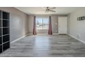 Bright living room with gray vinyl flooring, large window and ceiling fan at 2914 E Cactus Rd, Phoenix, AZ 85032