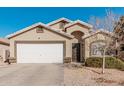 Tan house with white garage door and landscaping at 3854 W Yellow Peak Dr, San Tan Valley, AZ 85144