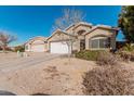 Tan house with white garage door and landscaping at 3854 W Yellow Peak Dr, San Tan Valley, AZ 85144