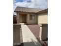 Front entryway with walkway and small, well-maintained yard at 42244 W Calle St, Maricopa, AZ 85138