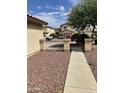 View of a side yard with a walkway and neighboring homes at 42244 W Calle St, Maricopa, AZ 85138