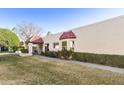 Well-maintained stucco home with red tile roof, landscaped lawn, and walkway at 649 S Arrowwood Way, Mesa, AZ 85208