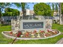 Graystone community entrance featuring a stone accented sign, manicured landscaping, and well-maintained greenery at 8366 S Grandview Ave, Tempe, AZ 85284