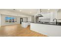 Open kitchen with stainless appliances, sleek granite countertops, and modern lighting at 1036 E Glenn Dr, Phoenix, AZ 85020