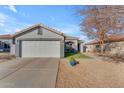 Single story home with attached garage and landscaped yard at 15854 W Gelding Dr, Surprise, AZ 85379