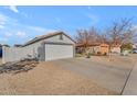 Single story home with attached garage and driveway at 15854 W Gelding Dr, Surprise, AZ 85379