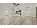 Open living room features a kitchen island and modern light fixtures at 15856 W Sage Trl, Surprise, AZ 85374