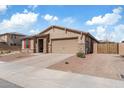 Well-maintained single-story home with tile roof, stone accents, and brick-paved driveway at 18188 W Fulton St, Goodyear, AZ 85338