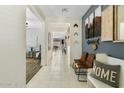 Inviting hallway with tile flooring, stylish decor, and a view into the living spaces at 18188 W Fulton St, Goodyear, AZ 85338