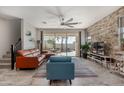Bright living room with modern decor, stone accent wall, and access to the backyard at 1921 E Lantana Dr, Chandler, AZ 85286