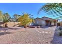 Large backyard with gravel, mature trees, and a hot tub at 19572 N Sandalwood Dr, Maricopa, AZ 85138