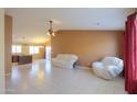 Spacious living room with tile floors and neutral color walls at 19572 N Sandalwood Dr, Maricopa, AZ 85138