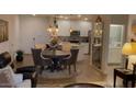 Open concept dining area with a round table and four chairs, adjacent to the kitchen at 2511 W Queen Creek Rd # 377, Chandler, AZ 85248