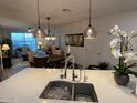 Kitchen features a large island with a white quartz countertop and modern sink at 2511 W Queen Creek Rd # 377, Chandler, AZ 85248