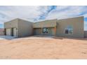A single-story home with a two-car garage, a covered entryway, and desert landscaping on a sunny day at 29340 N 231St Ave, Wittmann, AZ 85361