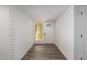 Clean entryway with white brick feature wall and hardwood floors at 3250 W Mercer N Ln, Phoenix, AZ 85029