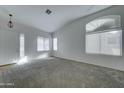 Bright and airy living room with neutral carpeting and large windows at 7037 W Pontiac Dr, Glendale, AZ 85308