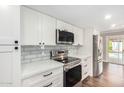 Modern kitchen with stainless steel appliances and white cabinets at 9412 N 33Rd Way, Phoenix, AZ 85028