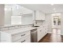 White kitchen with quartz countertops and subway tile backsplash at 9412 N 33Rd Way, Phoenix, AZ 85028