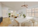 Bright dining area with white table, chairs, and large windows at 10245 W Jessie Ln, Peoria, AZ 85383