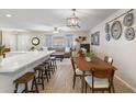 Bright dining area with hardwood floors and kitchen bar at 10537 W Prairie Hills Cir, Sun City, AZ 85351