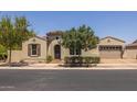 Charming single-story home featuring a tile roof, arched doorway, and a well-manicured front yard at 10550 E Sanger Ave, Mesa, AZ 85212