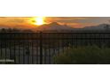 Spectacular sunset view from the backyard, showcasing the beauty of the surrounding mountains at 10888 N 136Th Pl, Scottsdale, AZ 85259