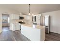 Modern kitchen with white cabinets, island, and stainless steel appliances at 11275 N 99Th Ave # 188, Peoria, AZ 85345