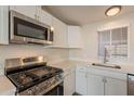 Stainless steel appliances and white shaker cabinets in kitchen at 11275 N 99Th Ave # 188, Peoria, AZ 85345