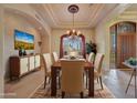 Elegant dining room featuring a large table and chandelier at 12238 E Poinsettia Dr, Scottsdale, AZ 85259