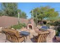 Relaxing patio with built-in fireplace and grill at 12238 E Poinsettia Dr, Scottsdale, AZ 85259