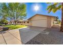 Attractive ranch home with a large garage and desert landscaping at 12923 W Ballad Dr, Sun City West, AZ 85375