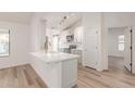 Modern kitchen with white cabinets, quartz countertops, and gold accents at 1326 W Seascape Dr, Gilbert, AZ 85233