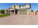 Two-story house with a brick driveway and a two-car garage at 15130 W Linden St, Goodyear, AZ 85338