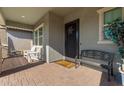 Inviting front porch with seating and a welcome mat at 15130 W Linden St, Goodyear, AZ 85338