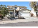 Two-story house with a three-car garage and desert landscaping at 17338 W Woodrow Ln, Surprise, AZ 85388