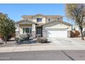 Two-story house with a three-car garage and desert landscaping at 17338 W Woodrow Ln, Surprise, AZ 85388