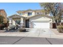 Two-story house with a three-car garage and desert landscaping at 17338 W Woodrow Ln, Surprise, AZ 85388