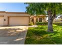 Single story home with attached garage and landscaped lawn at 18881 N 91St Dr, Peoria, AZ 85382