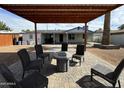 Relaxing backyard patio with covered seating area and fire pit at 1922 N 25Th St, Phoenix, AZ 85008