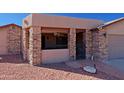 Enclosed front porch with stone columns and a charming gate at 19624 N 16Th Dr, Phoenix, AZ 85027