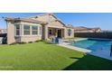 Spacious backyard with a refreshing pool and lush green grass at 21097 E Sparrow Dr, Queen Creek, AZ 85142