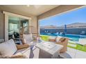 Relaxing patio with wicker furniture and a view of the pool at 21097 E Sparrow Dr, Queen Creek, AZ 85142