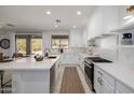 Modern white kitchen with center island, stainless steel appliances, and gold accents at 2128 E Leo Pl, Chandler, AZ 85249