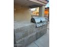 Outdoor kitchen with built-in grill and tile countertops at 2172 W Pinkley Ave, Coolidge, AZ 85128