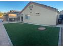 Artificial turf lawn, covered patio, and built-in BBQ at 2172 W Pinkley Ave, Coolidge, AZ 85128