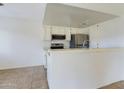 Bright kitchen features stainless steel appliances and a breakfast bar at 2228 E Campbell E Ave # 234, Phoenix, AZ 85016