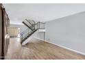 Open living area with wood-look floors and modern staircase at 225 N Standage -- # 77, Mesa, AZ 85201