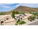 Aerial view showing a two-story house with solar panels and a mountain backdrop at 23046 N 21St St, Phoenix, AZ 85024