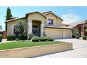 Two-story house with three-car garage, landscaped front yard, and a teal door at 23046 N 21St St, Phoenix, AZ 85024